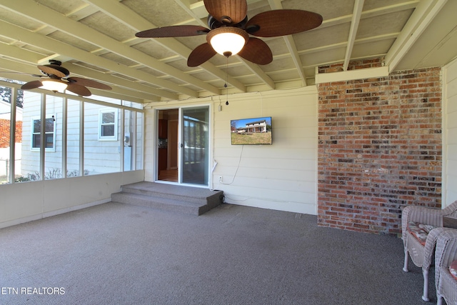 exterior space with ceiling fan and brick siding