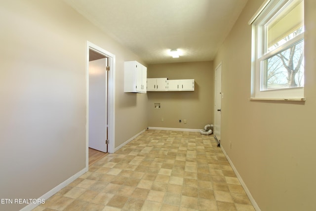 laundry area featuring washer hookup, hookup for an electric dryer, cabinet space, and baseboards