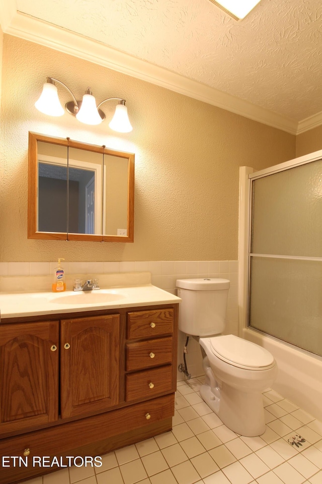 bathroom featuring tile walls, a textured ceiling, toilet, and tile patterned floors