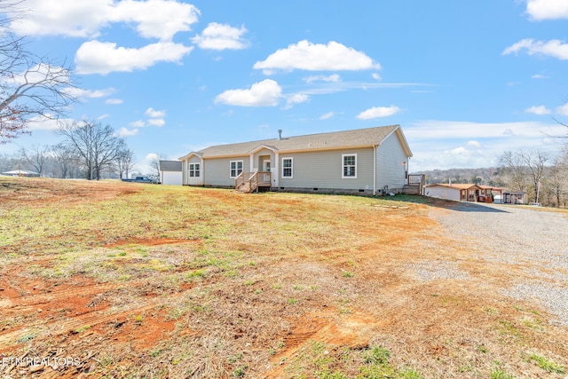 view of front of house featuring a front lawn and crawl space