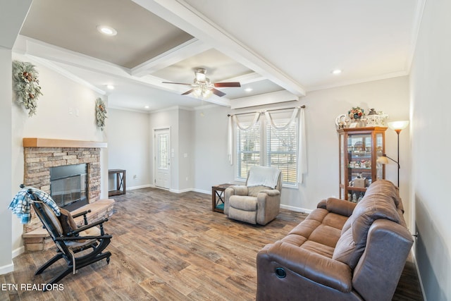 living room featuring wood finished floors, baseboards, beam ceiling, a glass covered fireplace, and crown molding