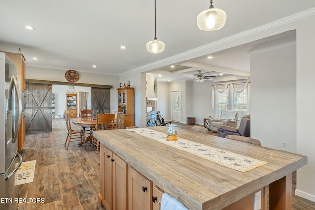 kitchen featuring butcher block counters, dark wood-style flooring, freestanding refrigerator, pendant lighting, and recessed lighting