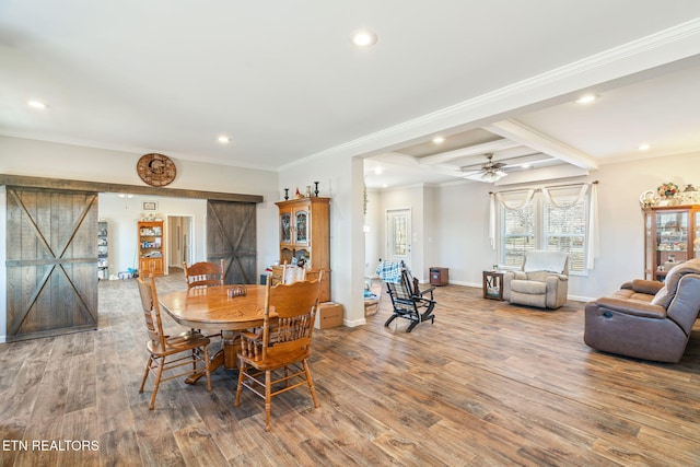 dining area featuring recessed lighting, wood finished floors, baseboards, and a barn door