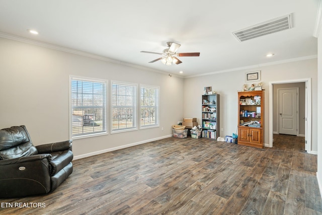 sitting room featuring baseboards, dark wood-type flooring, visible vents, and crown molding