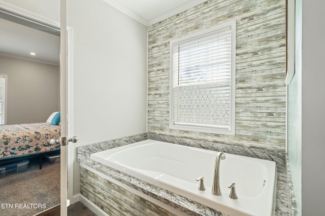 bathroom with a garden tub, ornamental molding, and ensuite bathroom