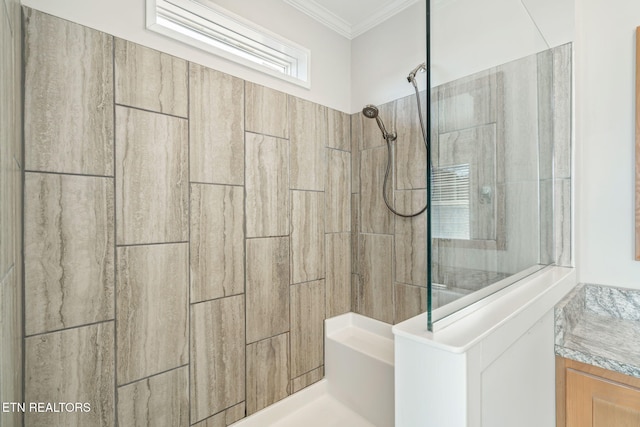 bathroom with tiled shower and crown molding