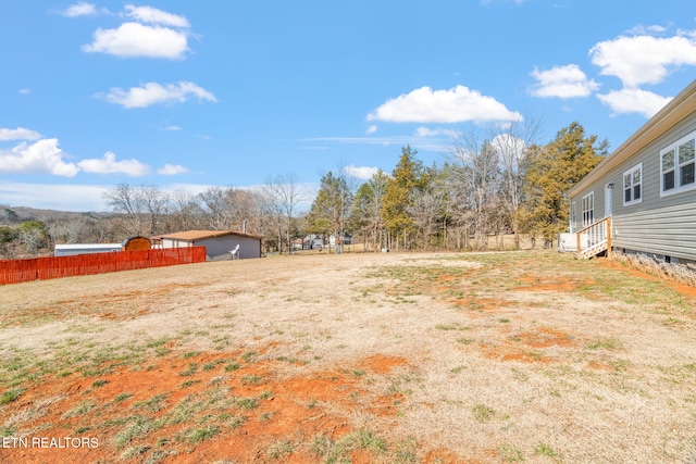 view of yard featuring entry steps and fence