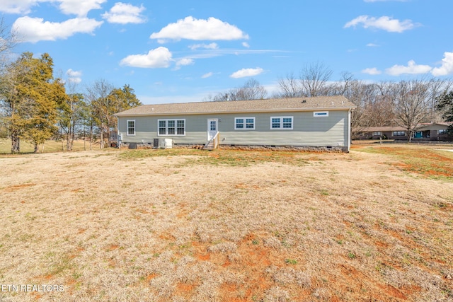 view of front of property with crawl space, entry steps, and a front yard