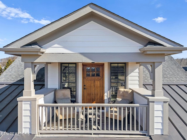 view of front of home featuring a porch and roof with shingles