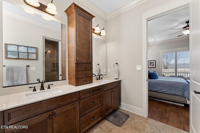 bathroom with crown molding, a sink, and ensuite bathroom