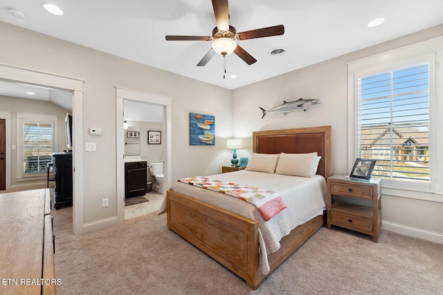 bedroom featuring baseboards, visible vents, and light colored carpet