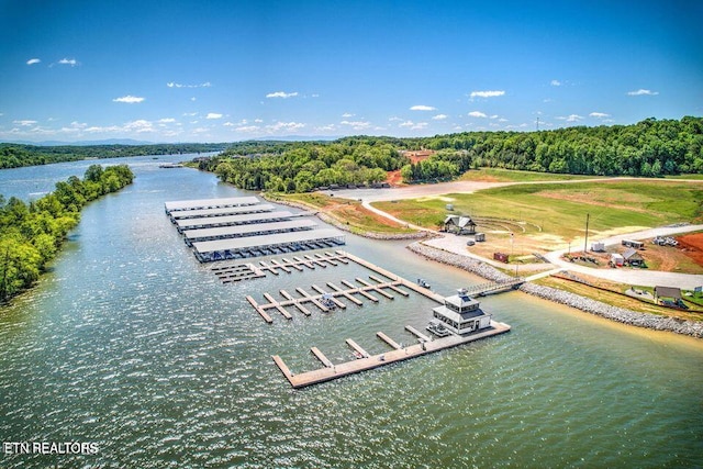 aerial view with a water view and a forest view