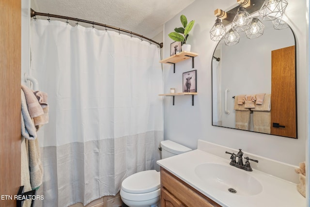 bathroom featuring curtained shower, a textured ceiling, toilet, and vanity