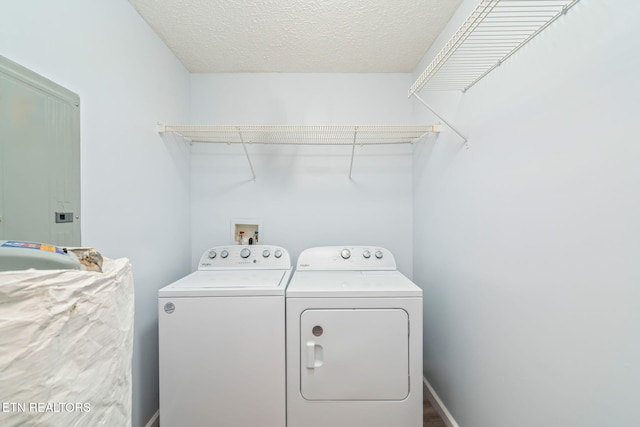 laundry room featuring baseboards, washer and clothes dryer, laundry area, a textured ceiling, and a sink