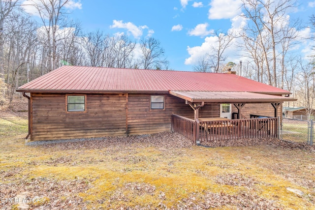 rear view of property featuring metal roof