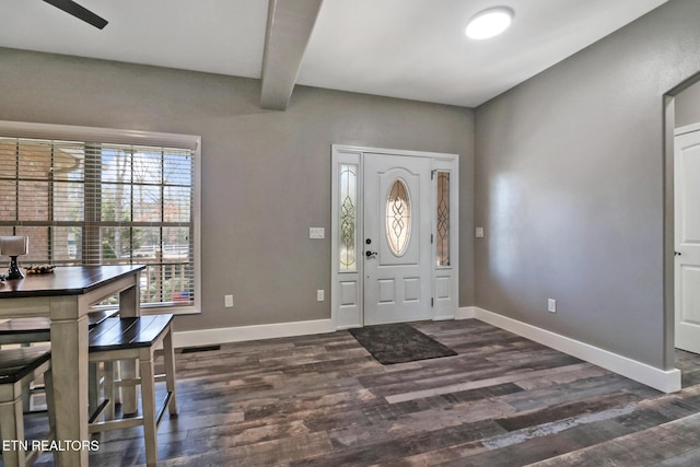 entryway featuring dark wood-style floors, baseboards, and beam ceiling