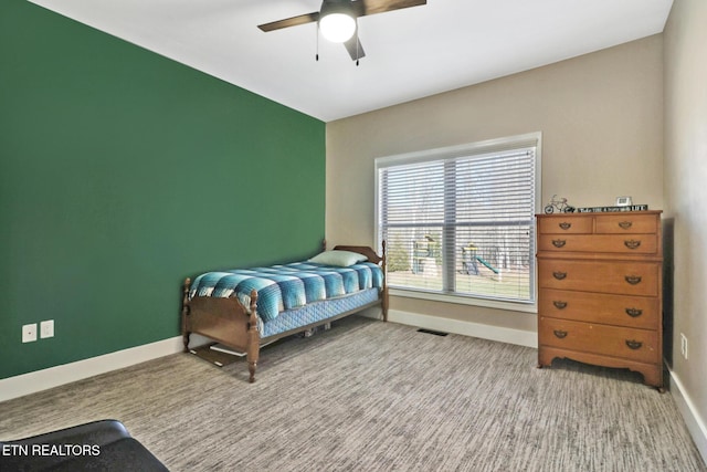 bedroom featuring light carpet, a ceiling fan, visible vents, and baseboards