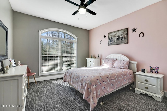 bedroom featuring a ceiling fan, dark colored carpet, and baseboards