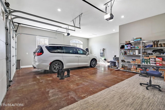 garage featuring a garage door opener, recessed lighting, and baseboards