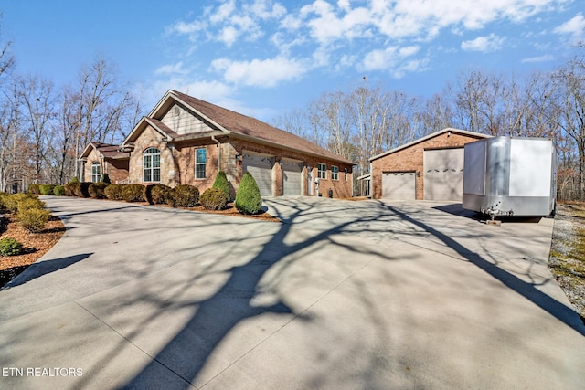 view of front of property with a garage, driveway, and brick siding