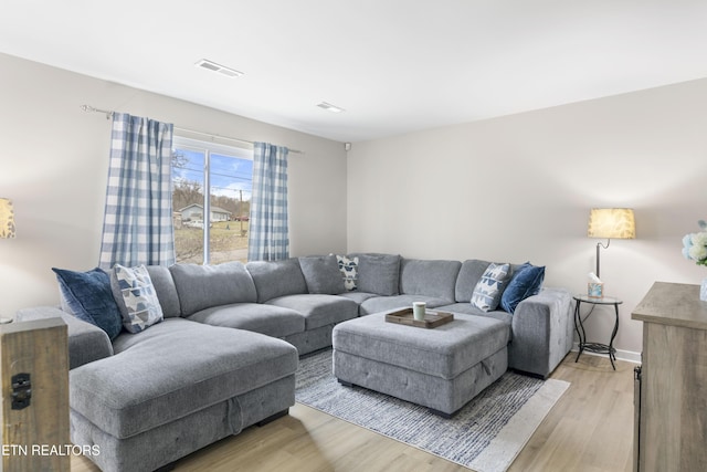 living area with visible vents and light wood-type flooring