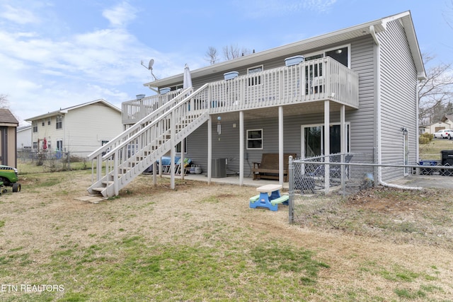 back of property featuring stairway, central air condition unit, a wooden deck, and fence