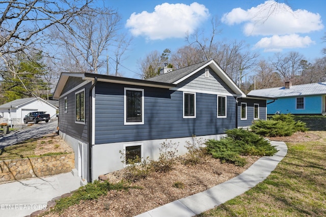 view of home's exterior featuring an outdoor structure