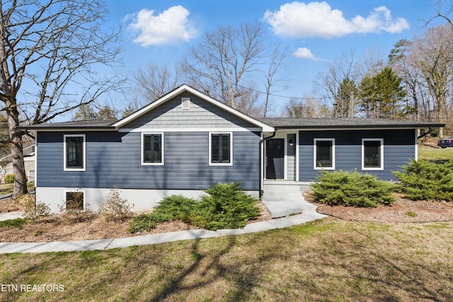 ranch-style house with a front lawn