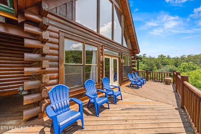 wooden deck featuring outdoor dining area