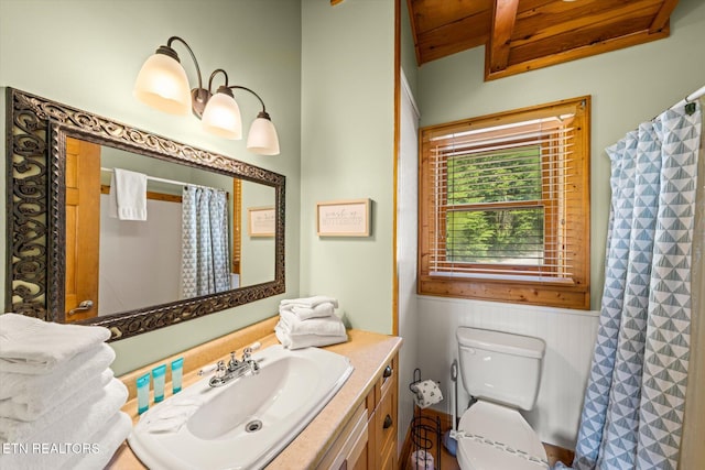 full bathroom featuring toilet, wooden ceiling, and vanity