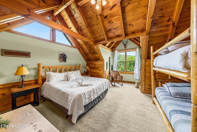 bedroom with vaulted ceiling with beams, carpet floors, wood ceiling, and baseboards