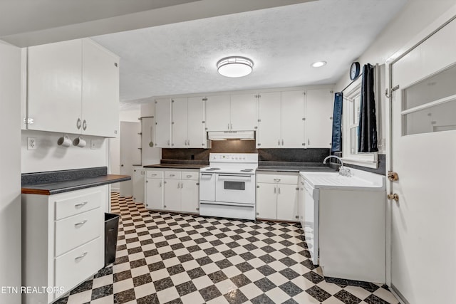 kitchen with under cabinet range hood, white cabinets, electric stove, backsplash, and tile patterned floors