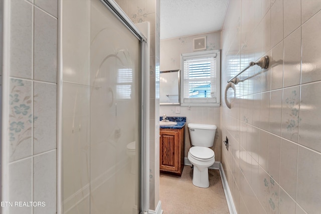 full bathroom featuring toilet, visible vents, vanity, tile walls, and a stall shower