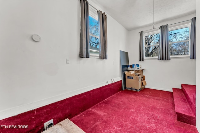 living area with dark colored carpet