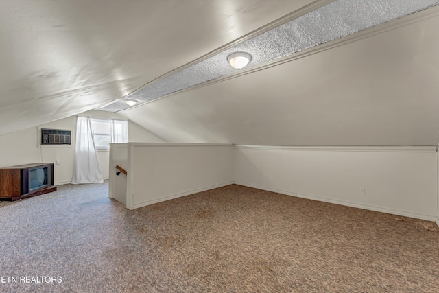 bonus room with carpet floors, baseboards, vaulted ceiling, and an AC wall unit