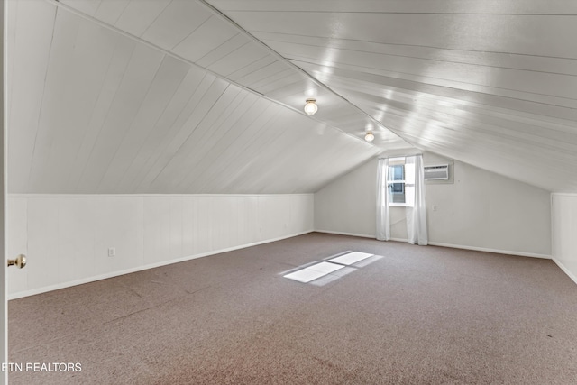 bonus room with carpet, vaulted ceiling, and a wall mounted AC