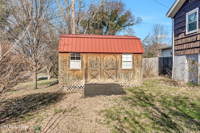 view of shed featuring fence