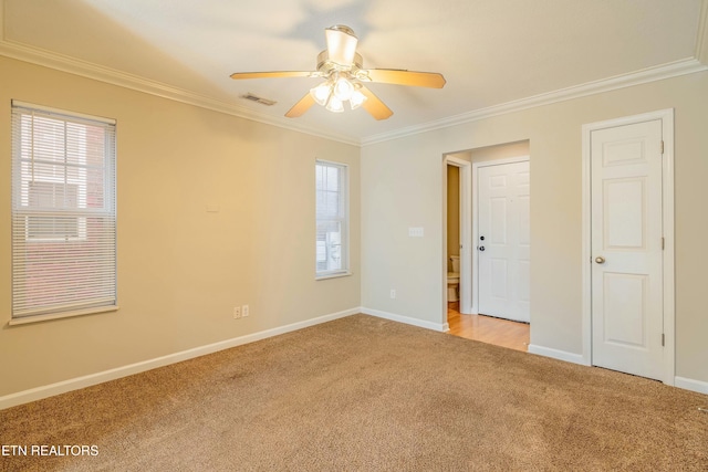unfurnished room with light carpet, a healthy amount of sunlight, and crown molding