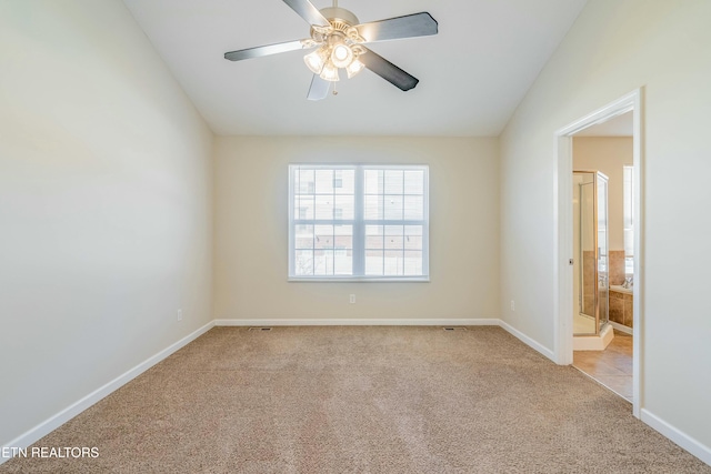 unfurnished room featuring light carpet, ceiling fan, and baseboards