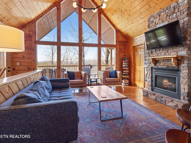 living area featuring wooden walls, wooden ceiling, plenty of natural light, and wood-type flooring