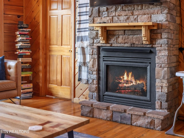 room details featuring a fireplace and wood finished floors