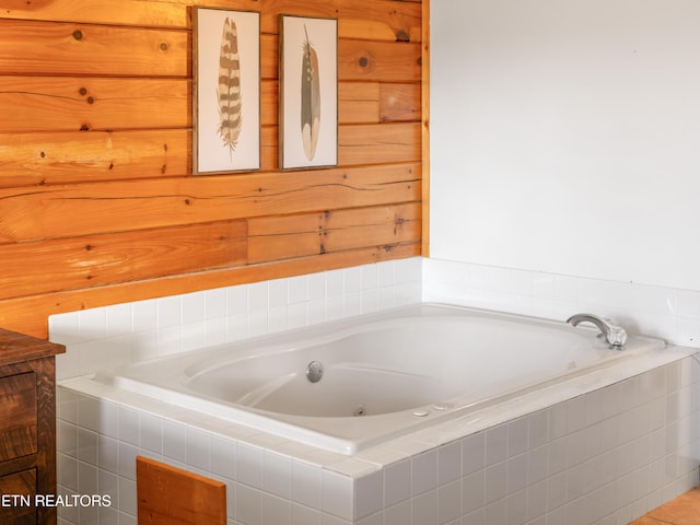 full bath featuring wood walls and a bath