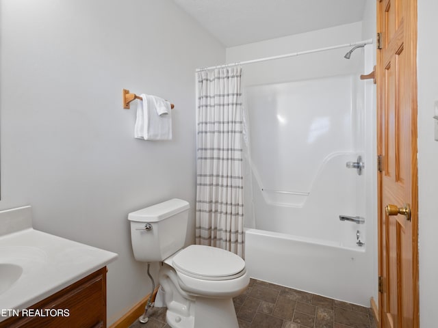 full bath with toilet, stone finish floor, shower / bath combo with shower curtain, and vanity