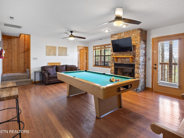 playroom featuring billiards, visible vents, wood finished floors, and a stone fireplace