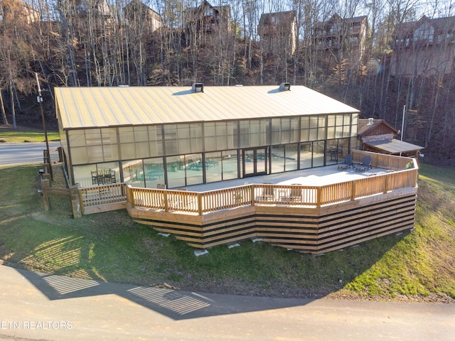 view of pool with a deck and a lawn