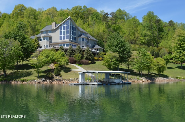 exterior space featuring a water view and a chimney