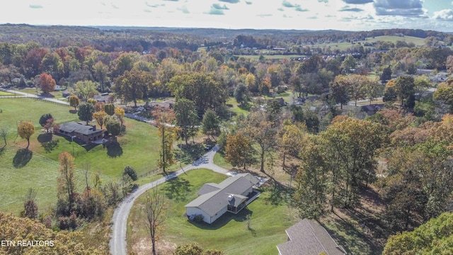 birds eye view of property with a forest view and a rural view