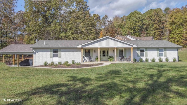 ranch-style home featuring an attached carport, brick siding, and a front lawn