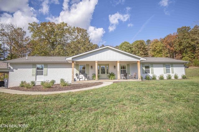 single story home with brick siding and a front yard