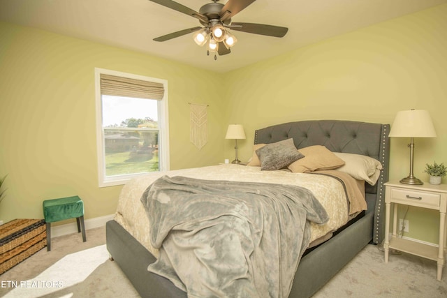 carpeted bedroom with a ceiling fan and baseboards